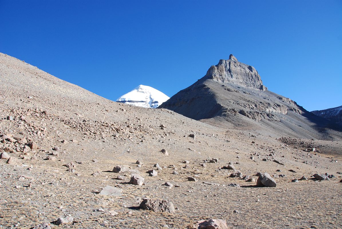 04 Mount Kailash South Face And Nandi From Confluence Of Two Rivers Early Morning On Mount Kailash Inner Kora Nandi Parikrama After leaving Ashtapad (07:30, 5171m), the sun finally comes over the ridge (08:00) and warms us as we reach the confluence of the two dry rivers coming from both sides of Nandi. The full south face of Mount Kailash is still partially hidden by the intervening ridge.